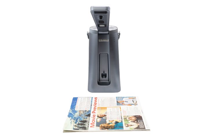 A close-up of the Odyssey Text-to-Speech reader capturing the text from a magazine.
