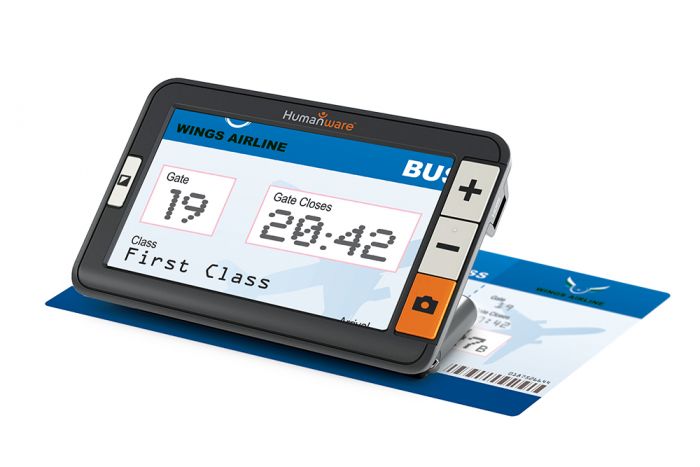Image of the exploré 5 on its built-in stand being used to enlarge information on a plane ticket.